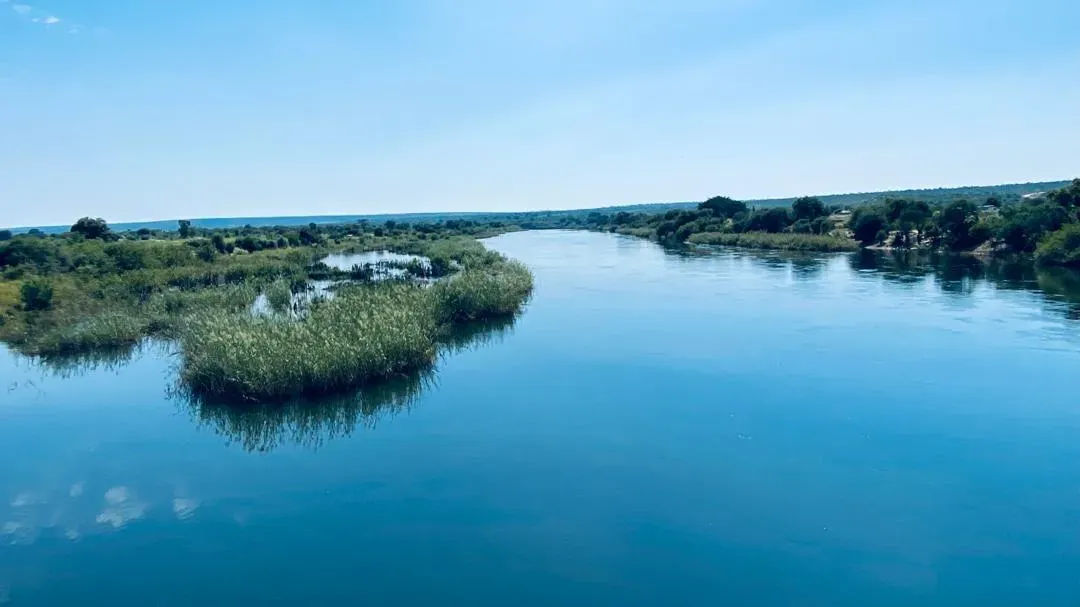 The wide, still Kavango River on the long road north
