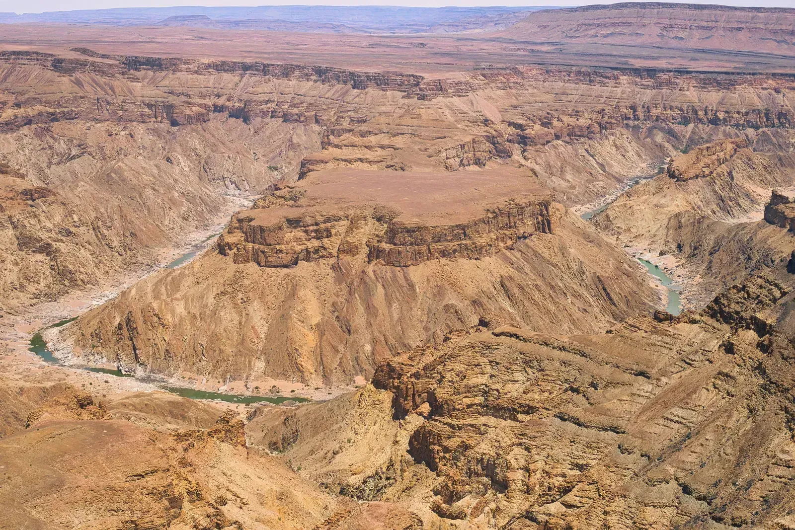 The river loops around a central massif on its way south