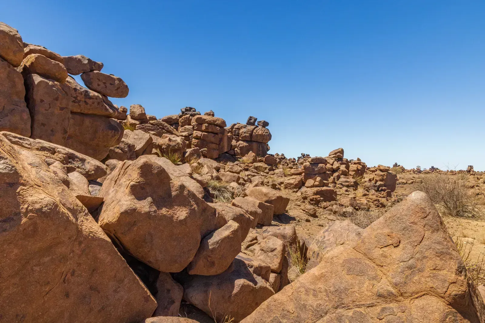 Boulders piled like a giant's building blocks against deep blue