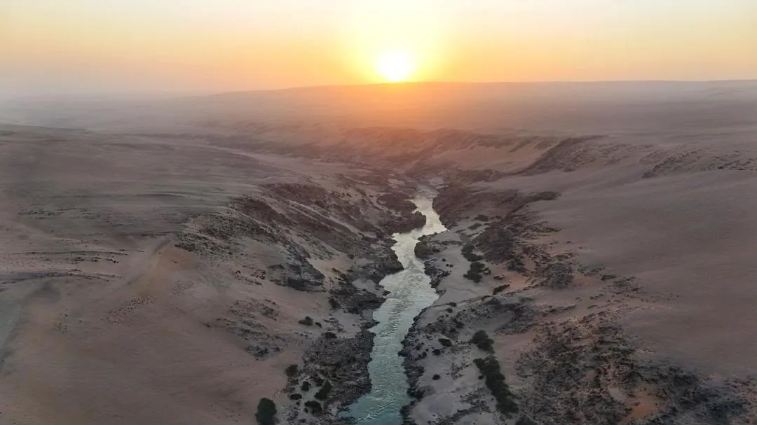 Sunset over the winding Kunene river between Dunes